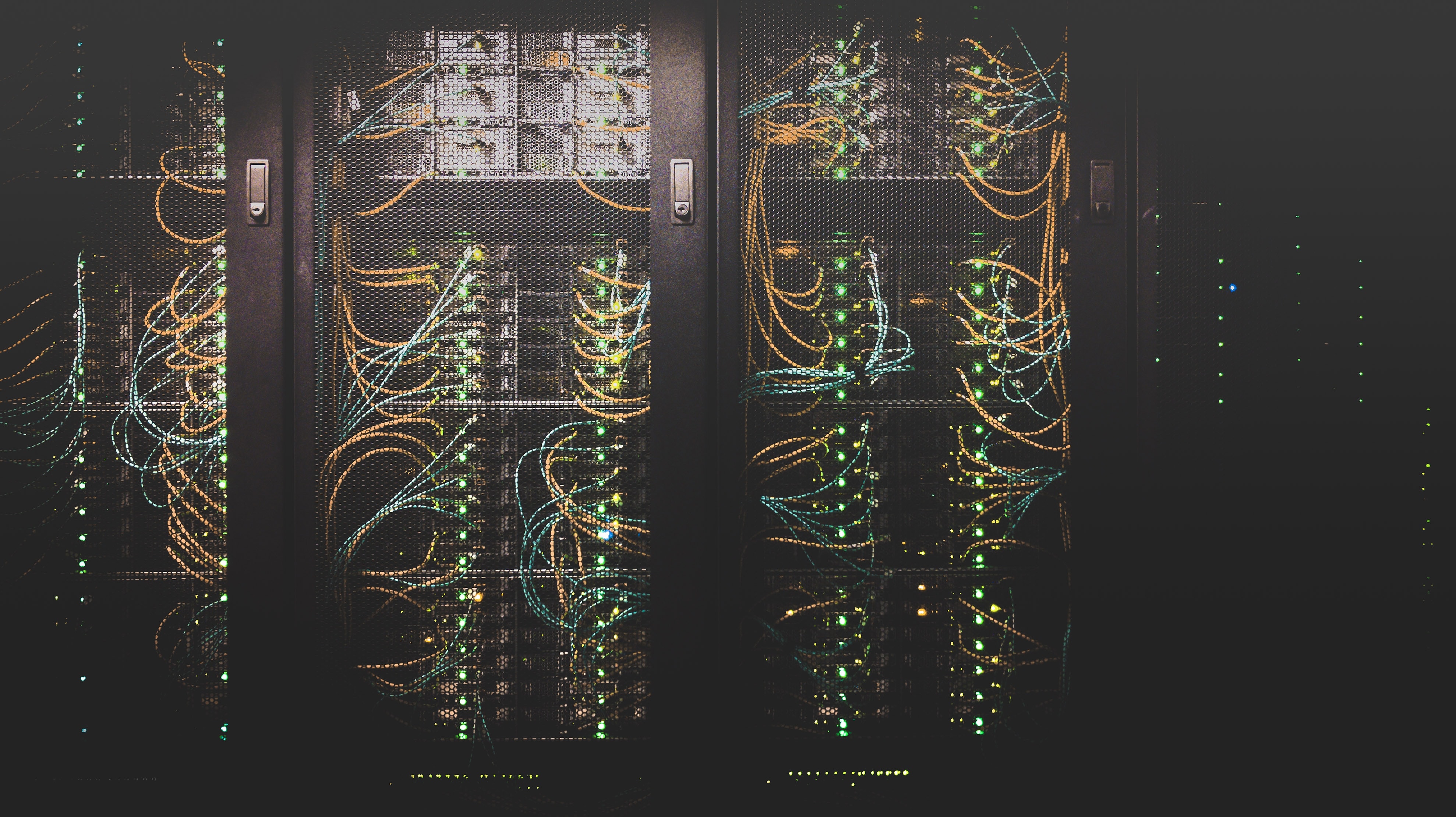 Three wired server racks with lights on